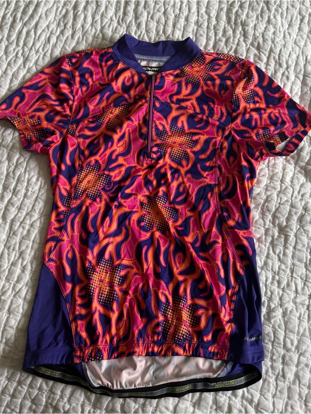 Woman’s size Small Nishiki Short Sleeve Cycling Jersey - Purple & Orange & Pink